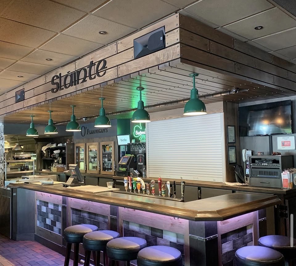 Commercial bar with wood millwork, metal detailing, and integrated lighting